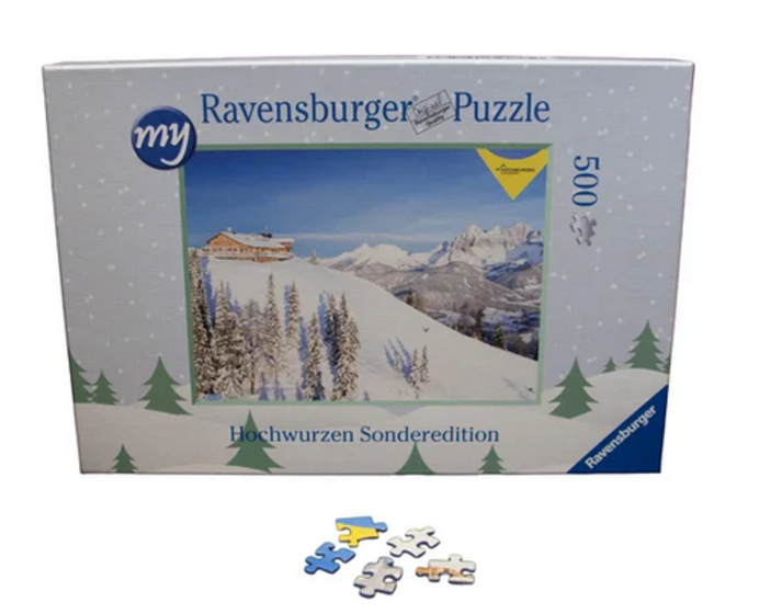 Puzzle box shows snowy mountain hut with fir trees and Alps in background, Hochwurzen edition, 500 pieces | © Planai-Hochwurzen-Bahnen GmbH